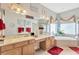 Bright bathroom features double sinks, vanity, soaking tub, and a window that lets in natural light at 20749 Auburn Leaf Trl, Land O Lakes, FL 34638