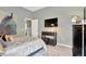 Bedroom features a television, decorative painting, and gray walls at 20749 Auburn Leaf Trl, Land O Lakes, FL 34638