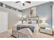 Bedroom boasts a queen bed, neutral decor, and a wall shelf for displaying decorative vases at 20749 Auburn Leaf Trl, Land O Lakes, FL 34638
