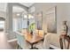 Elegant dining room with a wooden table, decorative art, and chandelier lighting at 20749 Auburn Leaf Trl, Land O Lakes, FL 34638