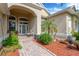 Inviting front entrance with brick pathway, lush greenery and front door at 20749 Auburn Leaf Trl, Land O Lakes, FL 34638