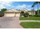 Inviting home featuring a three-car garage and a brick-paved driveway at 20749 Auburn Leaf Trl, Land O Lakes, FL 34638