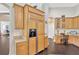 Kitchen featuring wooden cabinets and drawers with appliances, with a partial view to a desk area at 20749 Auburn Leaf Trl, Land O Lakes, FL 34638