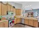 Well-equipped kitchen with stainless steel appliances, wooden cabinets, and granite countertops at 20749 Auburn Leaf Trl, Land O Lakes, FL 34638