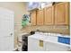 Functional laundry room with washer, dryer, utility sink, and ample cabinet storage at 20749 Auburn Leaf Trl, Land O Lakes, FL 34638