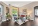Elegant living room featuring wood floors, ample seating, and large sliding glass doors at 20749 Auburn Leaf Trl, Land O Lakes, FL 34638