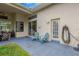 Outdoor patio with chairs, hose and a view of the backyard at 20749 Auburn Leaf Trl, Land O Lakes, FL 34638