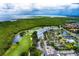 Aerial view of condo complex, golf course, and waterfront in a lush, green setting at 2333 Feather Sound Dr # B511, Clearwater, FL 33762