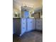 Bathroom featuring custom white cabinetry, a large mirror, and modern fixtures at 2333 Feather Sound Dr # B511, Clearwater, FL 33762