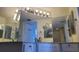 Bathroom featuring a large mirror, custom white cabinetry, modern fixtures, and tile flooring at 2333 Feather Sound Dr # B511, Clearwater, FL 33762