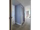 Bedroom view featuring neutral carpet, a closet, light blue accent wall, and bright natural light at 2333 Feather Sound Dr # B511, Clearwater, FL 33762