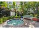 Inviting community hot tub surrounded by lush landscaping, offering a tranquil outdoor experience at 2410 W Azeele St # 228, Tampa, FL 33609