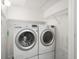 Convenient laundry room with washer, dryer, and wire shelving for organized storage at 2410 W Azeele St # 228, Tampa, FL 33609