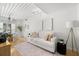 Airy living room with hardwood floors, white sofa, accent rug, and modern decor at 2410 W Azeele St # 228, Tampa, FL 33609