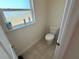 A half bathroom with a frosted window above the toilet at 26357 Trinilas Dr, Punta Gorda, FL 33983
