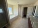 Bright bathroom with a tub, separate shower, dual vanities, and tiled floors at 26357 Trinilas Dr, Punta Gorda, FL 33983