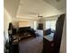 Bright bedroom featuring carpet flooring and a tray ceiling at 26357 Trinilas Dr, Punta Gorda, FL 33983