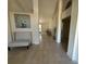 Open entryway with neutral tile, accent bench seating, and serene natural lighting at 26357 Trinilas Dr, Punta Gorda, FL 33983