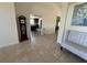 Bright foyer with tile floors featuring a grandfather clock and a decorative bench at 26357 Trinilas Dr, Punta Gorda, FL 33983