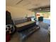 Cluttered two-car garage with an open door at 26357 Trinilas Dr, Punta Gorda, FL 33983