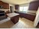 Well-lit kitchen with stainless steel appliances, a center island, and wood cabinetry at 26357 Trinilas Dr, Punta Gorda, FL 33983