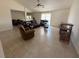 Spacious living room featuring tile flooring and a ceiling fan at 26357 Trinilas Dr, Punta Gorda, FL 33983
