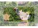 An aerial view of a home with a screened pool in a lush, green backyard at 2803 Bent Leaf Dr, Valrico, FL 33594