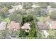 An aerial view of a home surrounded by lush greenery and mature trees in a quiet neighborhood at 2803 Bent Leaf Dr, Valrico, FL 33594