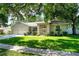 Traditional home with a beautiful lawn, mature trees, and a three-car garage at 2803 Bent Leaf Dr, Valrico, FL 33594