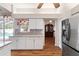 Bright kitchen with modern stainless-steel refrigerator and pool access visible at 2803 Bent Leaf Dr, Valrico, FL 33594