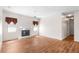 Bright living room featuring a fireplace, ceiling fan, and wood laminate flooring at 2803 Bent Leaf Dr, Valrico, FL 33594