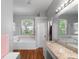 Bright and airy main bathroom featuring a soaking tub and a vanity with granite countertops at 2803 Bent Leaf Dr, Valrico, FL 33594