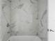 Shower and bathtub combination in bath has elegant marble tiles at 2912 W Santiago St # 1401, Tampa, FL 33629