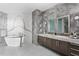 An opulent bathroom with gray marble walls, a soaking tub and double sink vanities at 2912 W Santiago St # 1401, Tampa, FL 33629