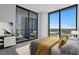 Bright bedroom boasts floor-to-ceiling windows, a balcony, and modern decor at 2912 W Santiago St # 1401, Tampa, FL 33629