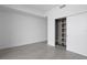 Bedroom has an open closet and grey tiled floors at 2912 W Santiago St # 1401, Tampa, FL 33629