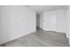 Empty room with gray wood floors and white walls with view of other rooms in the unit at 2912 W Santiago St # 1401, Tampa, FL 33629