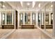Elegant hallway with mirrored walls and a sleek wooden bench, creating a bright and open space at 2912 W Santiago St # 1401, Tampa, FL 33629