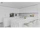 Modern kitchen features white cabinets, marble countertops, and bar seating at 2912 W Santiago St # 1401, Tampa, FL 33629