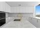Bright kitchen area with marble countertops, white cabinets, and a view at 2912 W Santiago St # 1401, Tampa, FL 33629