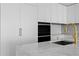 Kitchen view showcasing marble countertops, gold hardware, and white cabinets at 2912 W Santiago St # 1401, Tampa, FL 33629