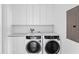 A laundry room with white cabinets and an Electrolux washer and dryer at 2912 W Santiago St # 1401, Tampa, FL 33629