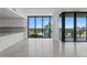 Bright and airy living room featuring floor-to-ceiling windows, modern finishes, and open kitchen at 2912 W Santiago St # 1401, Tampa, FL 33629