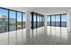 Bright and airy living room featuring floor-to-ceiling windows with beautiful water and city views at 2912 W Santiago St # 1401, Tampa, FL 33629