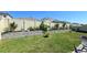 Landscaped backyard featuring a garden bed along the back fence, a lawn and patio furniture at 32313 Conchshell Sail St, Wesley Chapel, FL 33545