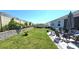 Spacious backyard with a patio, lawn, garden bed and privacy fence, perfect for outdoor enjoyment at 32313 Conchshell Sail St, Wesley Chapel, FL 33545