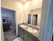 Bathroom boasts double sinks, granite countertops, and neutral tones, leading to the bedroom at 32313 Conchshell Sail St, Wesley Chapel, FL 33545