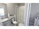 Well-lit bathroom with a granite-topped vanity, modern shower, and neutral tones at 32313 Conchshell Sail St, Wesley Chapel, FL 33545