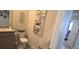A half bathroom features a granite countertop, sink, toilet, and modern fixtures at 32313 Conchshell Sail St, Wesley Chapel, FL 33545