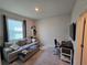 Bedroom area features a couch and desk, window with blinds and plenty of natural light at 32313 Conchshell Sail St, Wesley Chapel, FL 33545